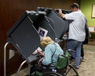 West Austin voters cast ballots in early voting at an Austin Public Library branch on October 30, 2013.