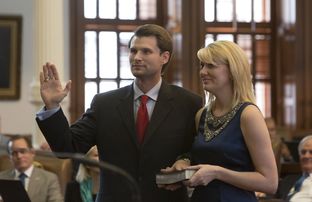 Leighton Schubert R-La Grange as he is sworn-in as Texas Representative for district #331 on March 3rd, 2015.Next to him is his wife Brittany