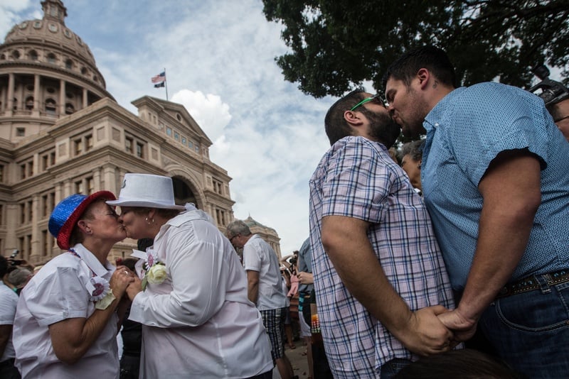 Couples embrace at the conclusion of the "Big Gay Wedding" ceremony on the south lawn of the Texas Capitol on July 4 after the Supreme Court legalized same-sex marriage in June. 