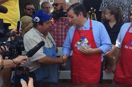 U.S. Sen. Ted Cruz, R-Texas, eats a pork chop sandwich Friday at the Iowa State Fair. Cruz fielded questions throughout his trip to the fair about real estate mogul Donald Trump's controversial immigration proposals.