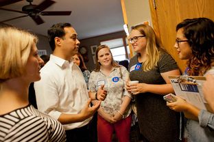 U.S. Rep. Joaquin Castro, D-San Antonio, talks to staffers from Hillary Clinton's Iowa campaign at a morning campaign event in Iowa City on Sunday, August 30, 2015.