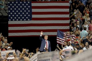 Presidential contender Donald Trump enters the rally at the American Airlines Center in Dallas on Sept. 14, 2015.