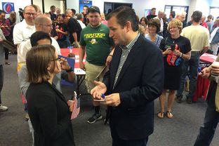 Presidential contender and U.S. Sen. Ted Cruz speaks with a supporter at the opening of his first Iowa office in Urbandale, Iowa on Sept. 26, 2015.