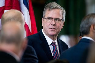 Former Florida Governor Jeb Bush visits with friends in the Texas Senate chamber after seeing his son George P. Bush, 38, sworn into office as the Texas Land Commissioner.  The elder Bush has signaled that he's planning on running for U.S. President in 2016.