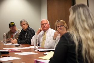 Texas Agriculture Commissioner Sid Miller looks on during a lunchtime "Faith at Work" session at the Stephen F. Austin state office building. Such weekly meetings are organized by Michael Tummillo, who Miller named the official volunteer chaplain at his Department of Agriculture.