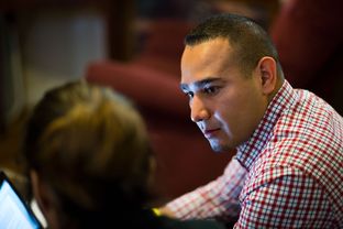 Child Protective Services Investigator Daniel Hernandez interviews family members during a home visit on Mar. 31, 2016.