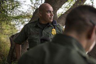 Border Patrol Agent José Perales peers out across the Rio Grande in Roma, Texas, while searching for a group of five undocumented immigrants reported to have crossed the river in a raft from Ciudad Miguel Alemán, Mexico, on March 8, 2016.