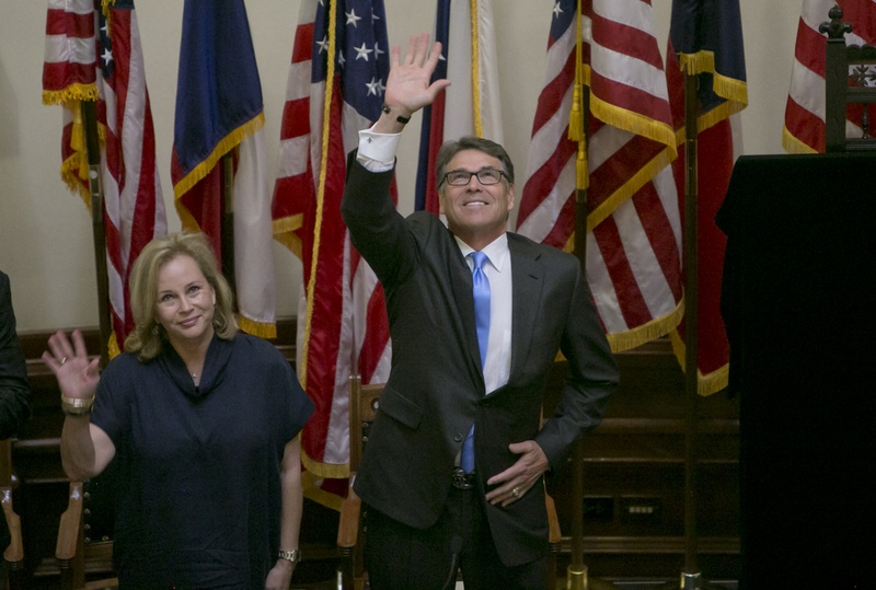 Gov. Rick Perry, waves to the crowd during the unveiling ceremony of his official portrait inside the Capitol rotunda on May 6th, 2016