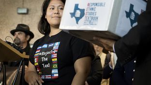 Carolina Hernandez, a student in the Houston ISD, spoke during a news conference at the Texas Education Agency on Nov. 15, 2016, about a proposed Mexican-American studies textbook that educators and activists have criticized. As Hernandez spoke, she glanced at a box holding 15,000 petitions against the textbook.