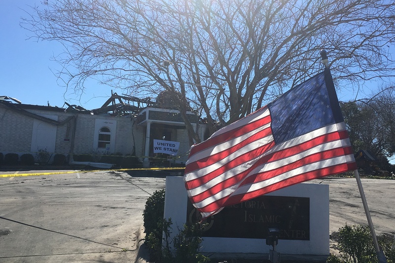 An American flag flies in front of a fire-ravaged mosque in Victoria on Feb. 1, 2017.