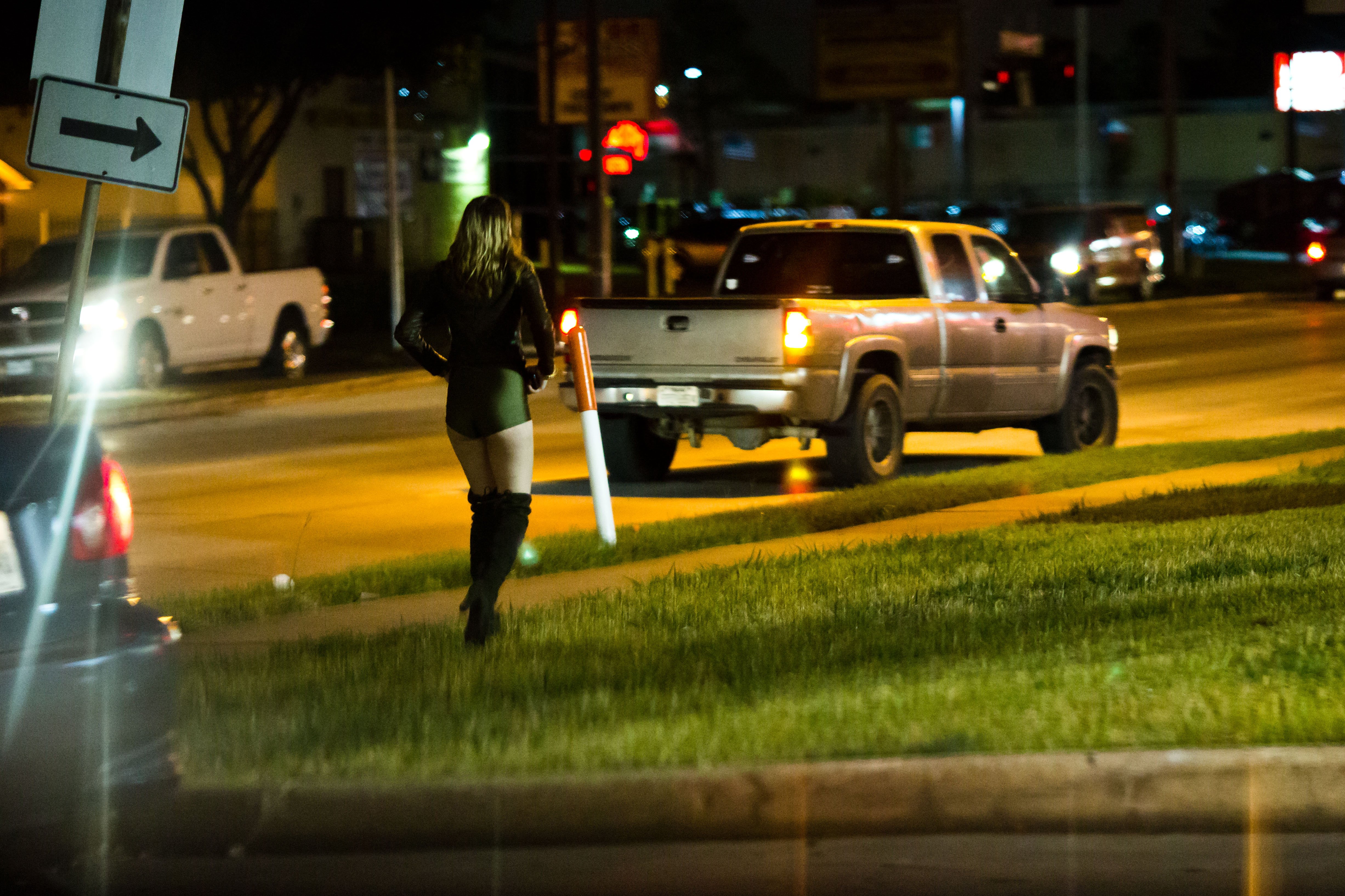 Potential johns circle an area known for prostitution in Houston. Pimps wait nearby in strip mall parking lots.