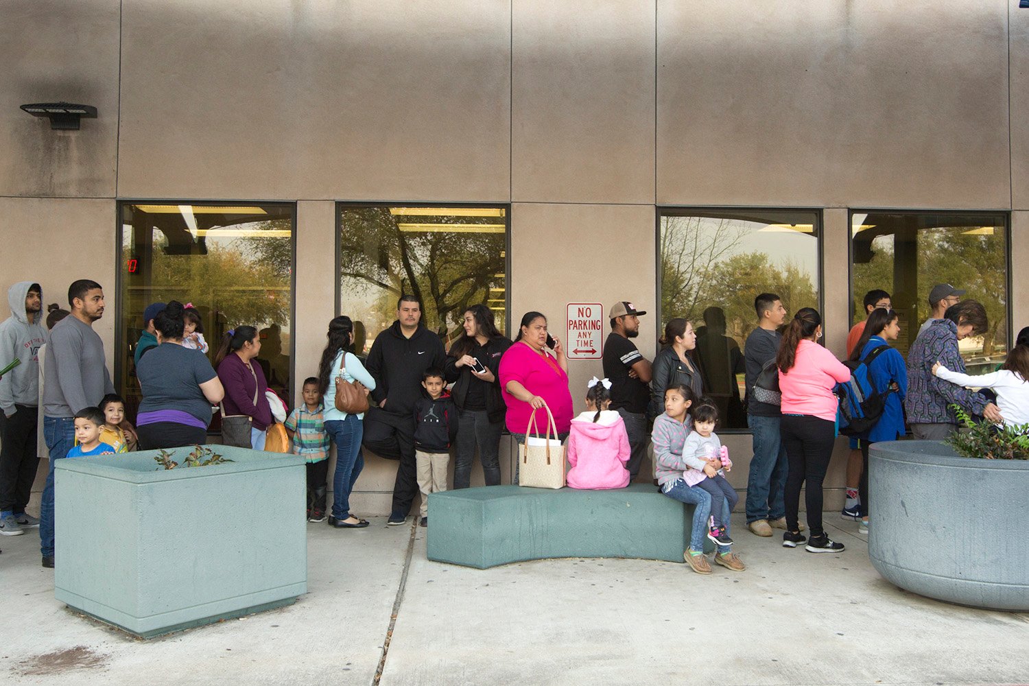 Families wait in line outside Travis County's passport office. Undocumented parents fearing deportation visited the office to get passports for their American children.