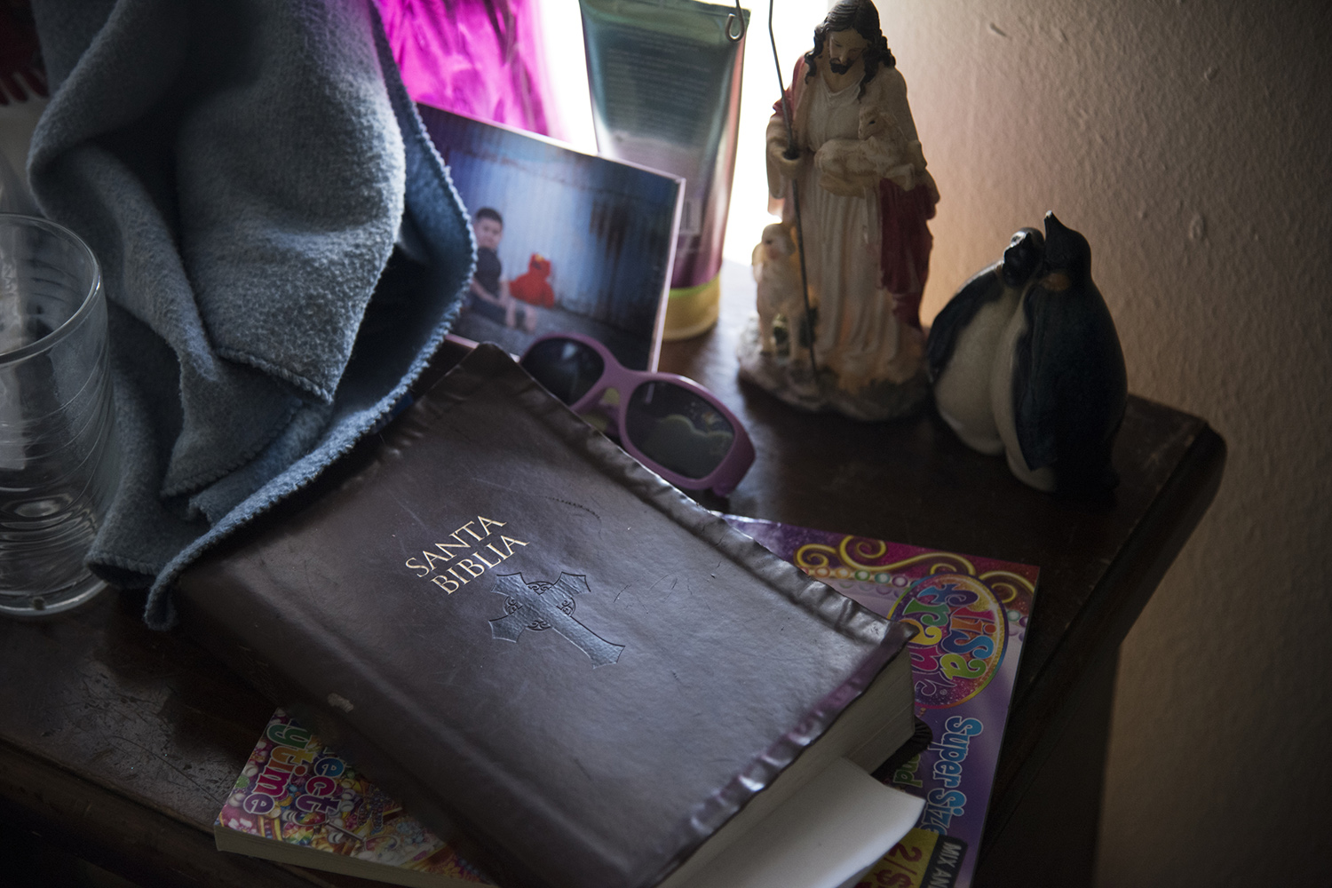 The Bible is next to the couch with old family photos in Grand Prairie. 