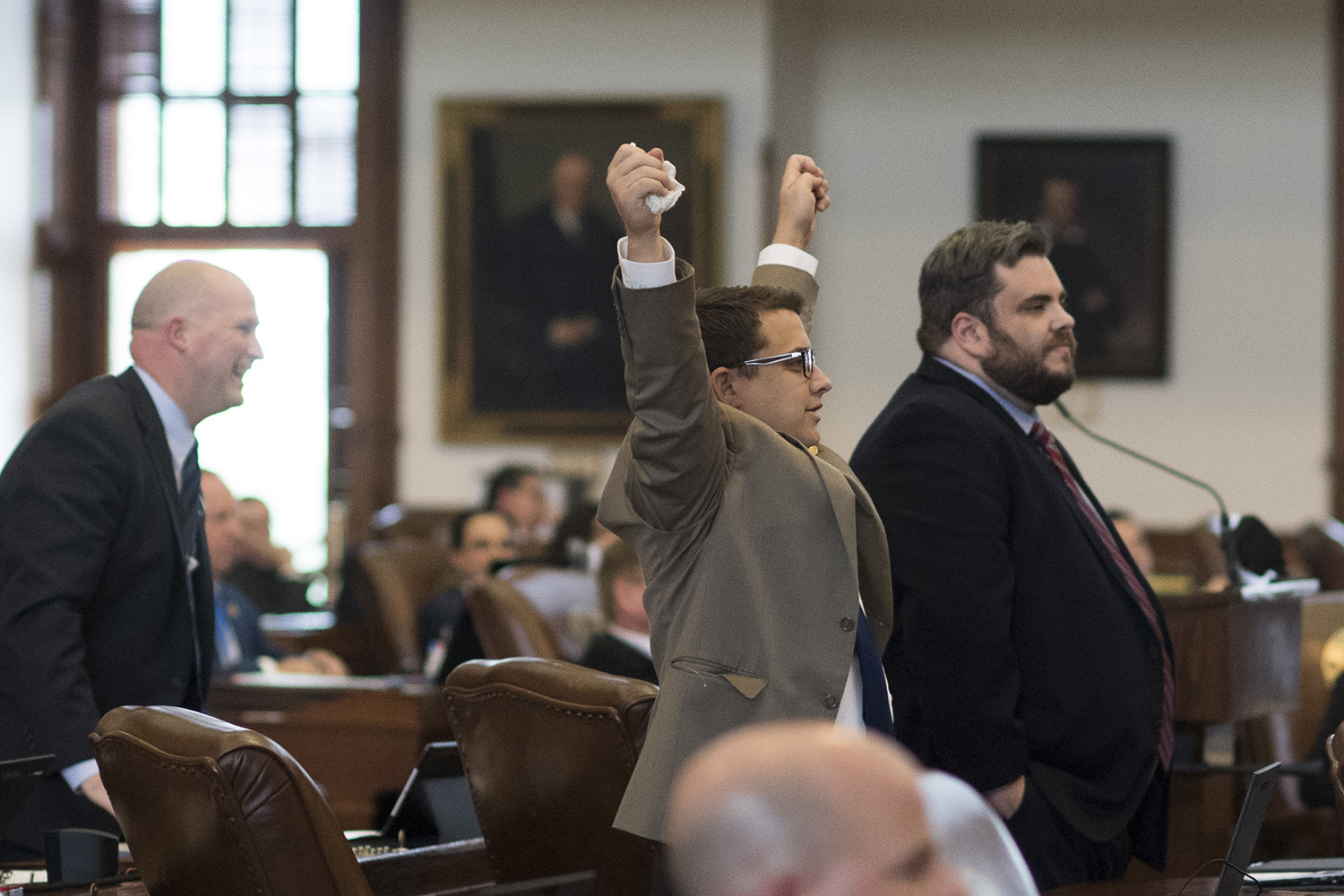 4:40 p.m.  State Rep. Briscoe Cain, R-Deer Park, one of the members of the Texas Freedom Caucus, raises his arms in celebration. 