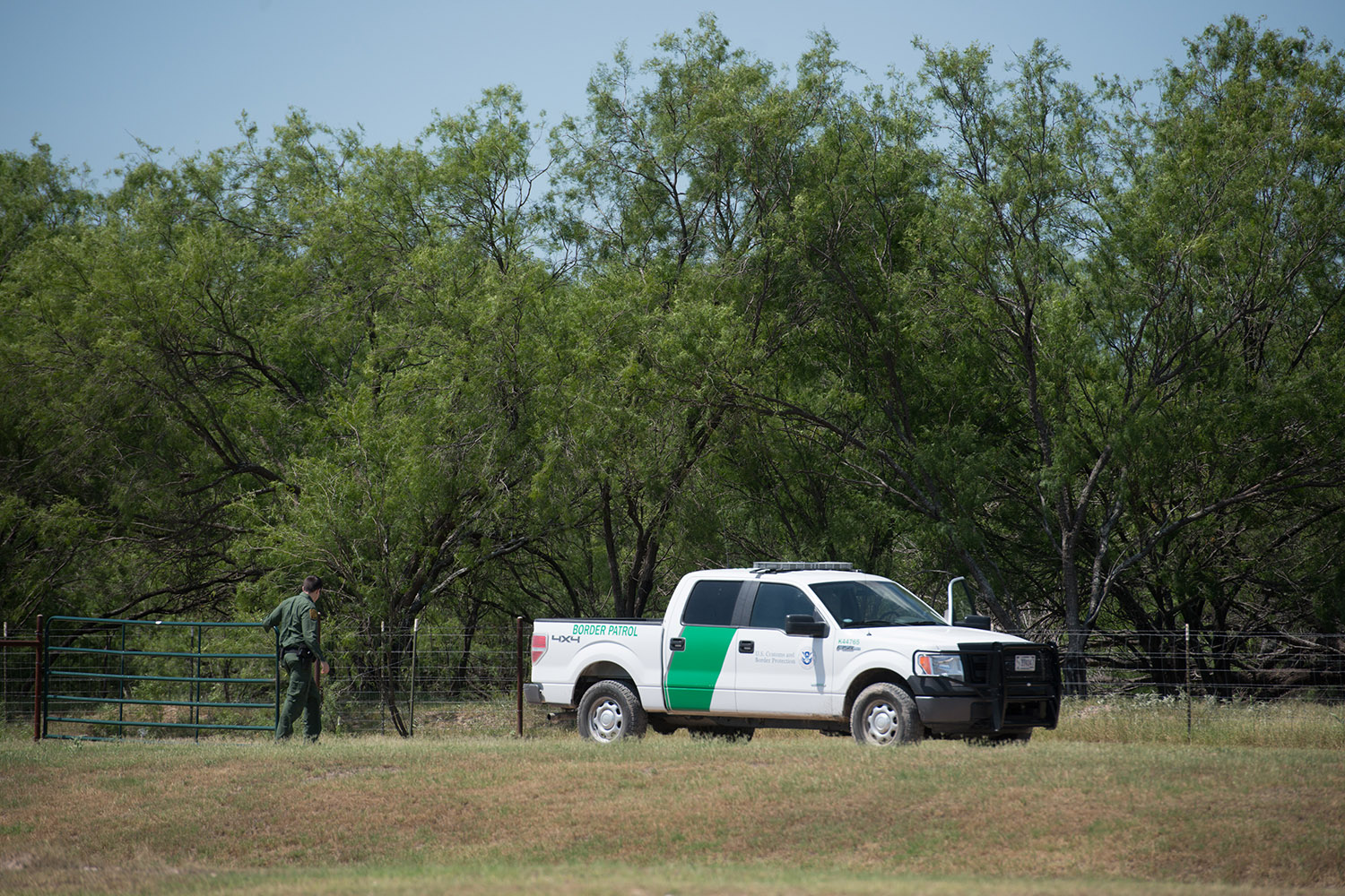 A Border Patrol agent closes a gate at the Eagle Point development in Eagle Pass.  