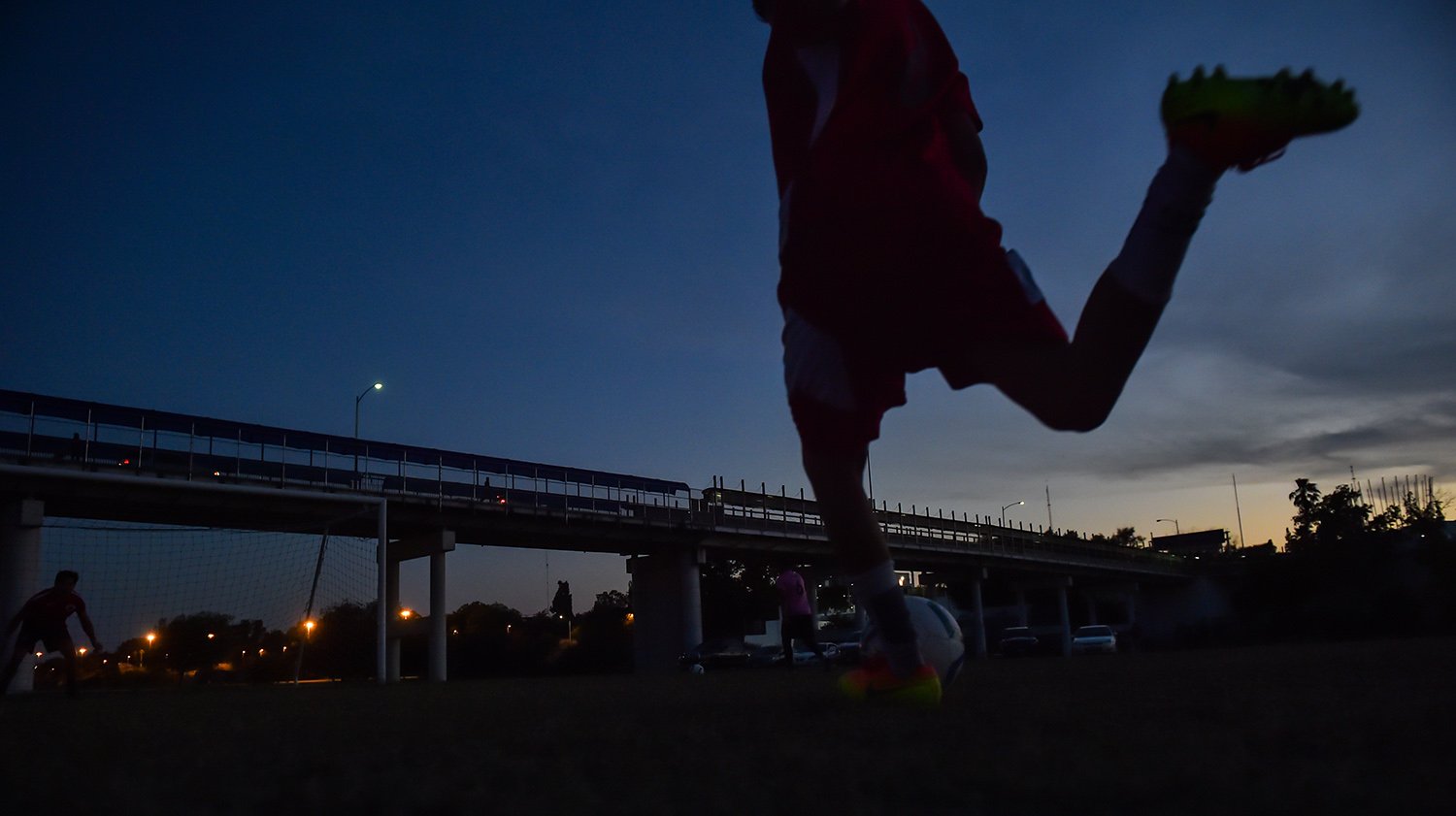 A soccer player on the Twin Cities FC team practices at a municipal park in Eagle Pass. Soccer players are concerned that a new wall could run through the city's only public soccer field. 