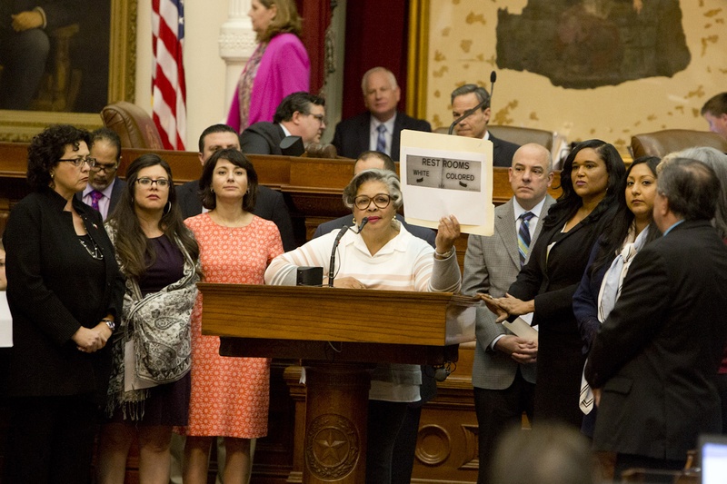 During a debate on the "bathroom bill," state Rep. Senfronia Thompson, D-Houston, holds up a photo of a sign that reads, "RESTROOMS WHITE COLORED," on May 21, 2017.