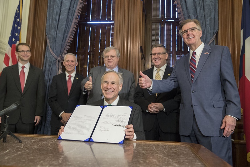 After signing it into law on May 25, Gov. Greg Abbott displays Senate Bill 7, which&nbsp;toughens the penalties for inappropriate student-teacher relationships. In the background: Texas Education Agency Commissioner Mike Morath, State Rep. Gary VanDeaver, R-New Boston, Sen. Paul Bettencourt, R-Houston, State Rep. Tony Dale, R-Cedar Park and Lt. Gov. Dan Patrick.&nbsp;
