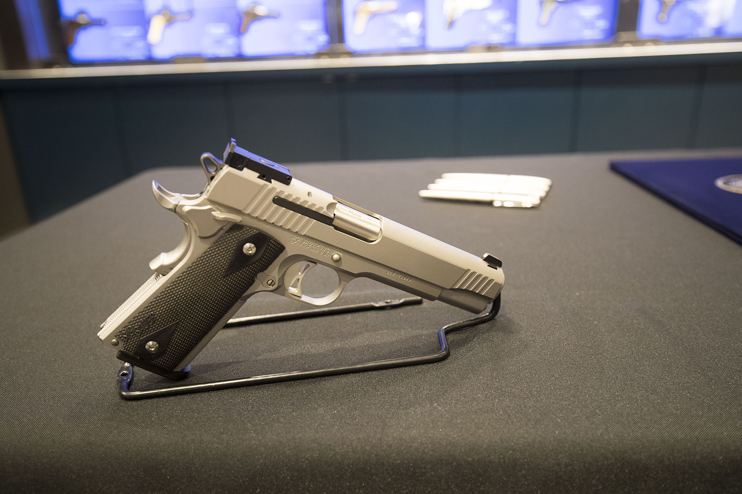 A Sig Sauer P320 9mm handgun, with Gov. Abbott's signing pens behind it, at a shooting range in Austin. The governor signed Senate Bill 6, which reduces the first-time fee for a license to carry handguns, at the range, on May 26, 2017.