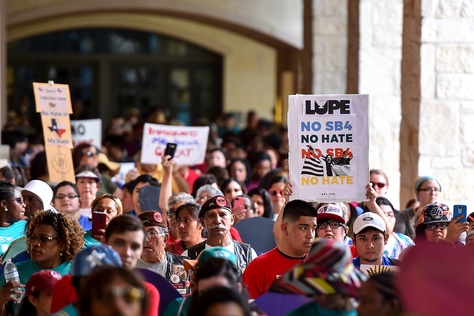 People demonstrating against Senate Bill 4, the "sanctuary cities" ban, march near the Riverwalk in San Antonio on June 26, 2017. U.S. District Judge Orlando Garcia is hearing opening arguments from Texas cities and counties challenging the measure, signed into law by Gov. Greg Abbott.
