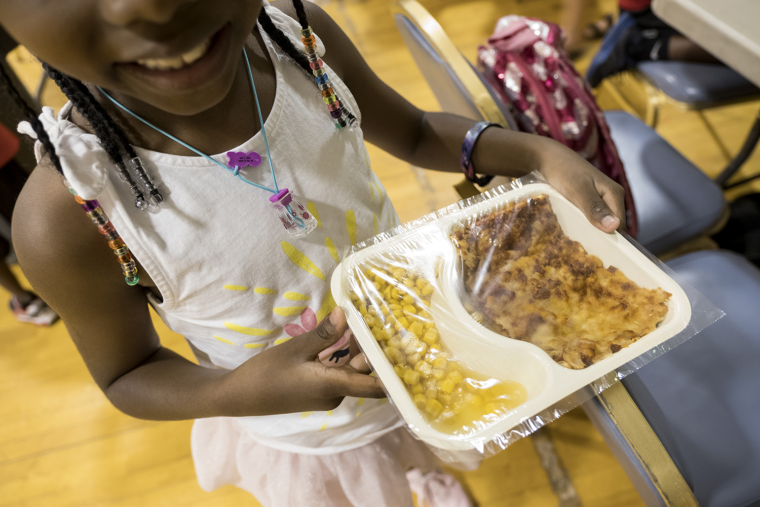 Jasmyn Spivey, 6, carries her lunch to the table at Jarvis Christian College in Hawkins, one of 77 sites the East Texas Food Bank sponsors to serve free food to hungry students.