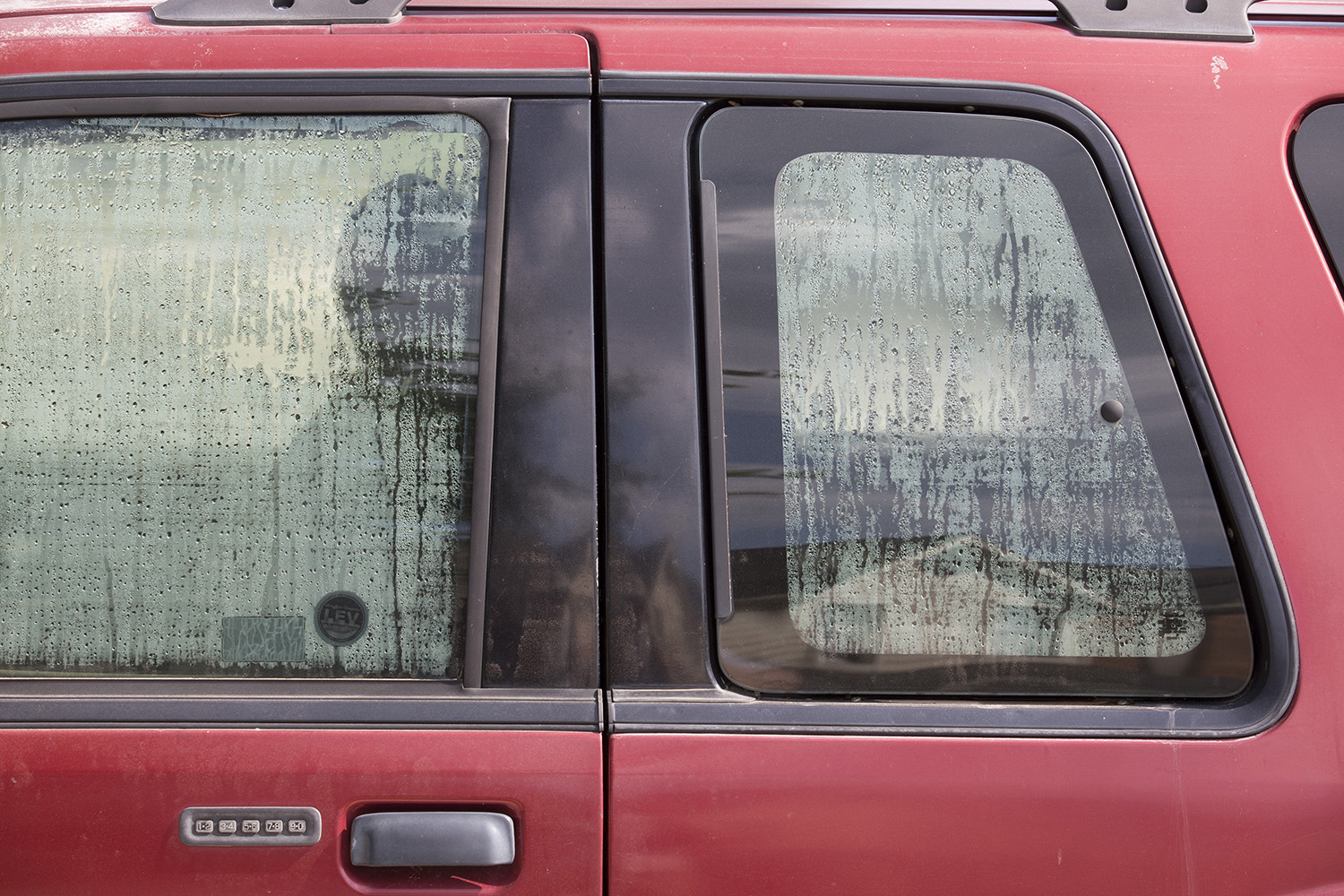 The windows of Eddie Rogers' flooded Ford Explorer steam up on the inside.