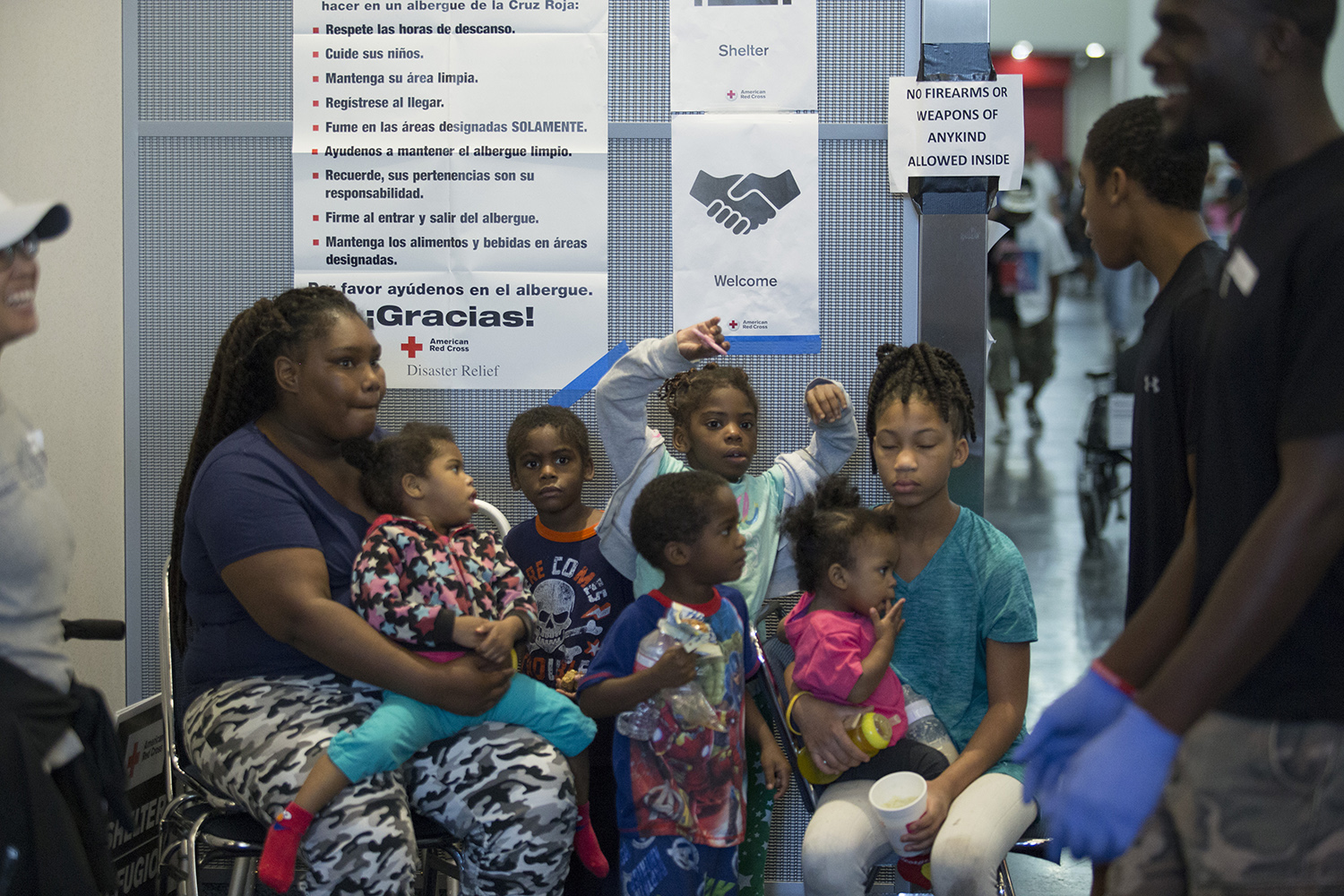 Haley Gray, whose home and car was flooded and was rescued by helicopter, sits with her kids and her sister's kids at the George R. Brown Convention Center in downtown Houston on Thursday, Aug. 31, 2017.