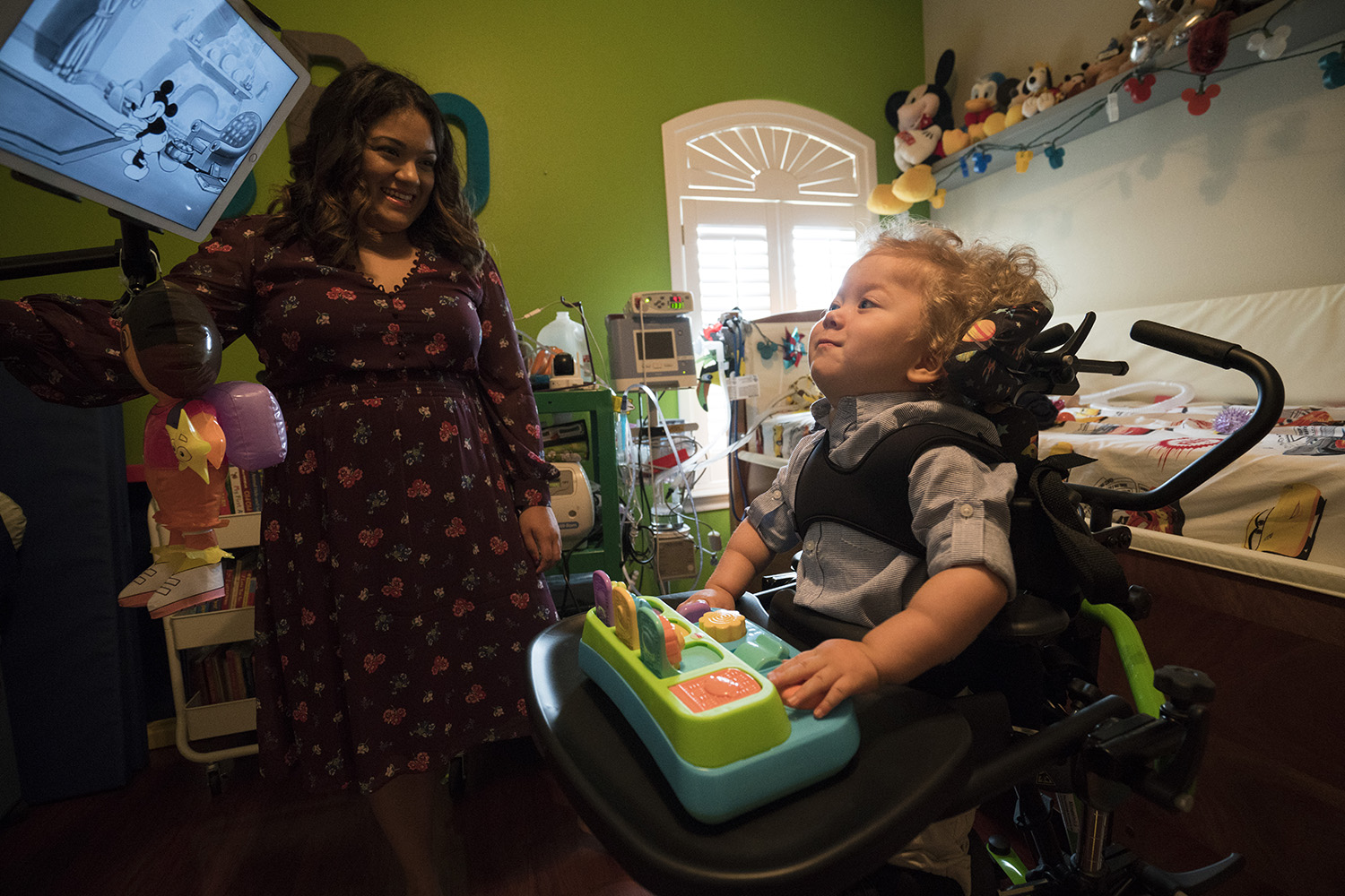 Jack Resendez watches cartoons from his pediatric standing frame. Though spinal muscular atrophy immobilizes children, it does not affect their ability to learn.