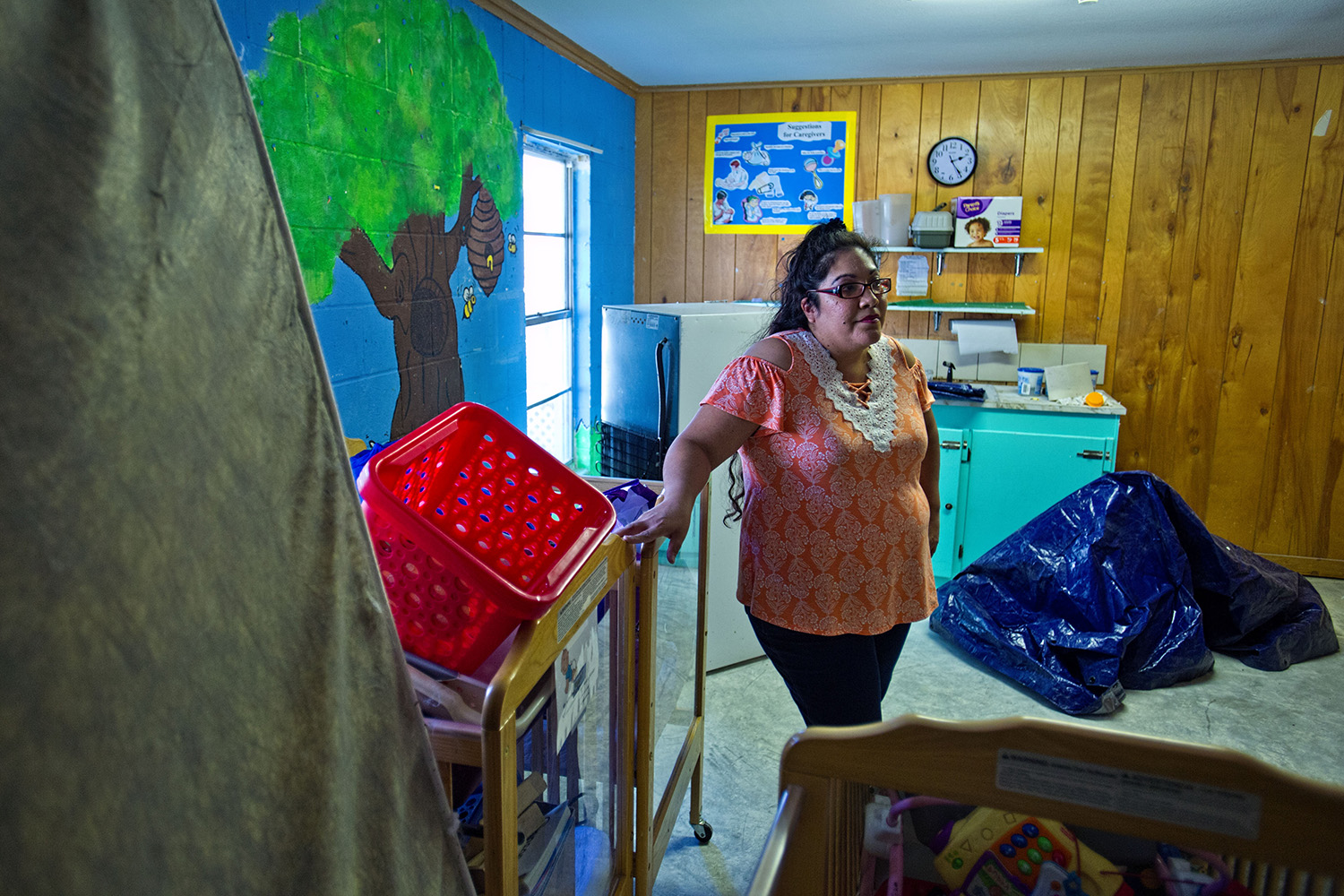 LaVeta Rodriguez, director of the Little Lights Learning Center, stands among the unused cribs, toys and equipment in the baby room at the center.