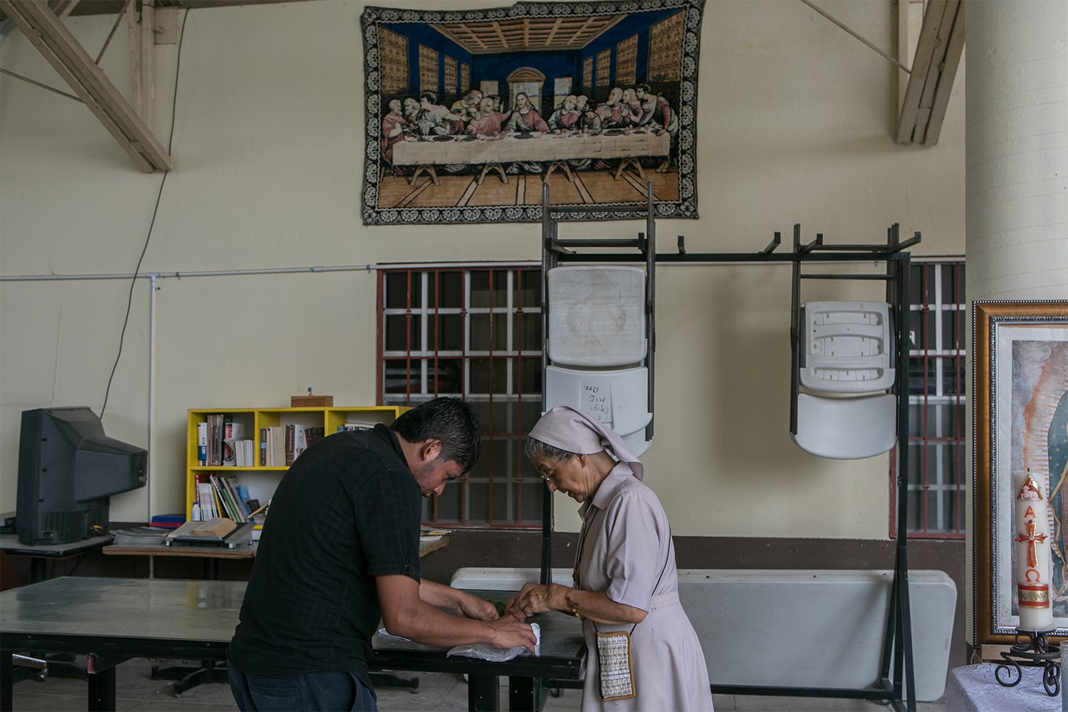  A nun helps a patient with his medication at Casa del Migrante Reynosa Guadalupe in Reynosa, Mexico, on May 2, 2017. According to the director of the shelter, the majority of the people staying at the shelter are recent deportees from the United States.