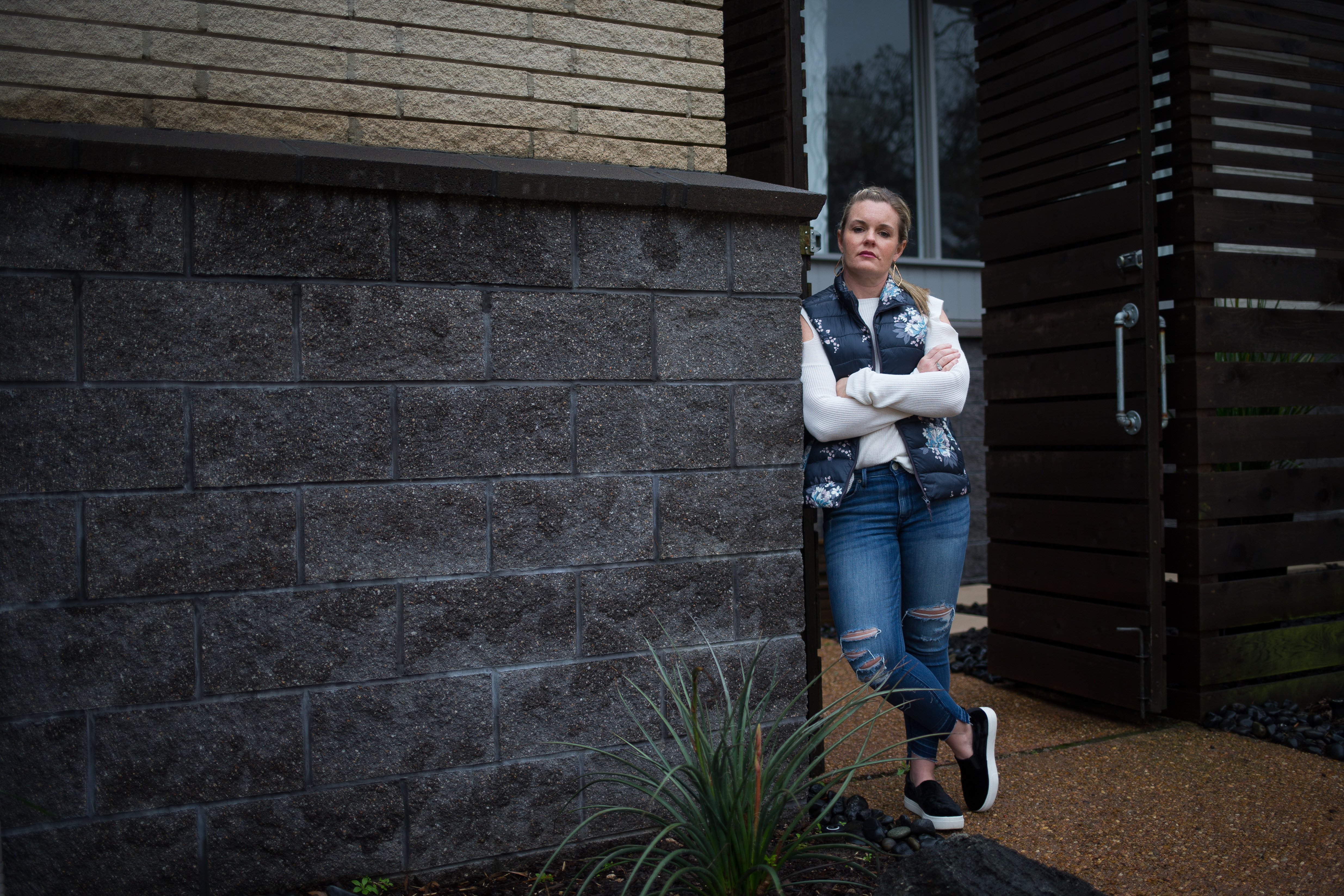 Erin Anders stands in front of her family's home in Houston's Meyerland neighborhood on Feb. 13, 2018. Anders and her husband, Doug Anders, elevated their home in 2017 prior to Hurricane Harvey, saving it from potentially catastrophic damage. The couple and their two children evacuated using inflated pool floats as the floodwaters rose around their home.