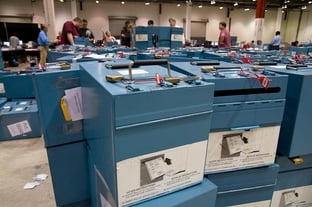 Paper-ballot boxes flood Reliant Center, where Harris County officials convened to count thousands of paper ballots.
