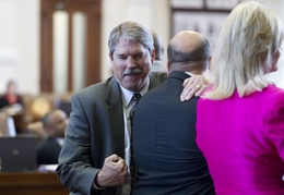 State Rep. Larry Taylor (l), R-League City, plays around with State Rep. Armando Martinez (c), D-Weslaco  on the House floor on March 21, 2011.