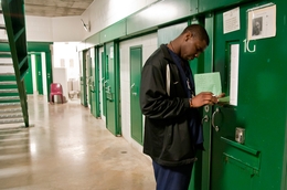 Christopher Ajayi, a psychiatric technician, makes his rounds at the Harris County Jail.