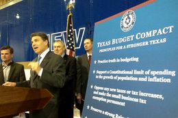 Gov. Rick Perry unveils his "Texas Budget Compact" in Houston on Monday, April 16. On stage with Perry, from left to right: state Reps. Brandon Creighton, R-Conroe, and Wayne Smith, R-Baytown, and conservative activist Michael Quinn Sullivan.