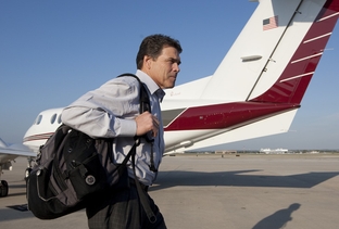 Texas Gov. Rick Perry departs a private plane at the San Antonio International Airport during a campaign stop on November 1, 2010