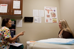 La'Tonya Ephraim speaks with Carrie Adney, a Women's Health Program client since last year, at Seton-Circle of Care Women's Services in Round Rock, TX.