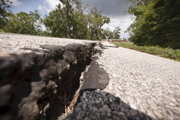 Cracks have formed in the asphalt on Bayou Wood Circle near County Road 687 south of Angleton, Texas Tuesday Aug, 2, 2011.