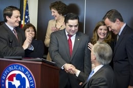 State Representative J.M. Lozano (center) shakes hands with Attorney General Greg Abbott as he announces that he's switching to the Republican Party during a press conference Thursday, March 18, 2012.