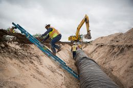 Water pipeline crew members prepare for the laying of a section of the 60-mile-long chain running near Eden, Texas, in 2012.