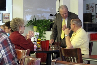 Rep. Delwin Jones (standing) talks to voters in a Lubbock diner.